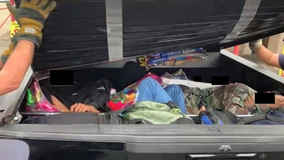 Migrants trapped inside the bed cover of a pickup truck.
