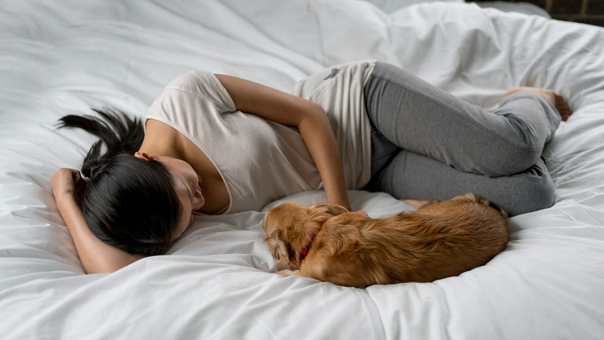 woman sleeps with dog