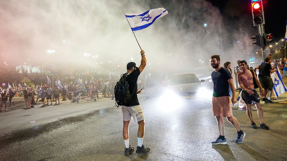 Israeli protester holding flag in the air