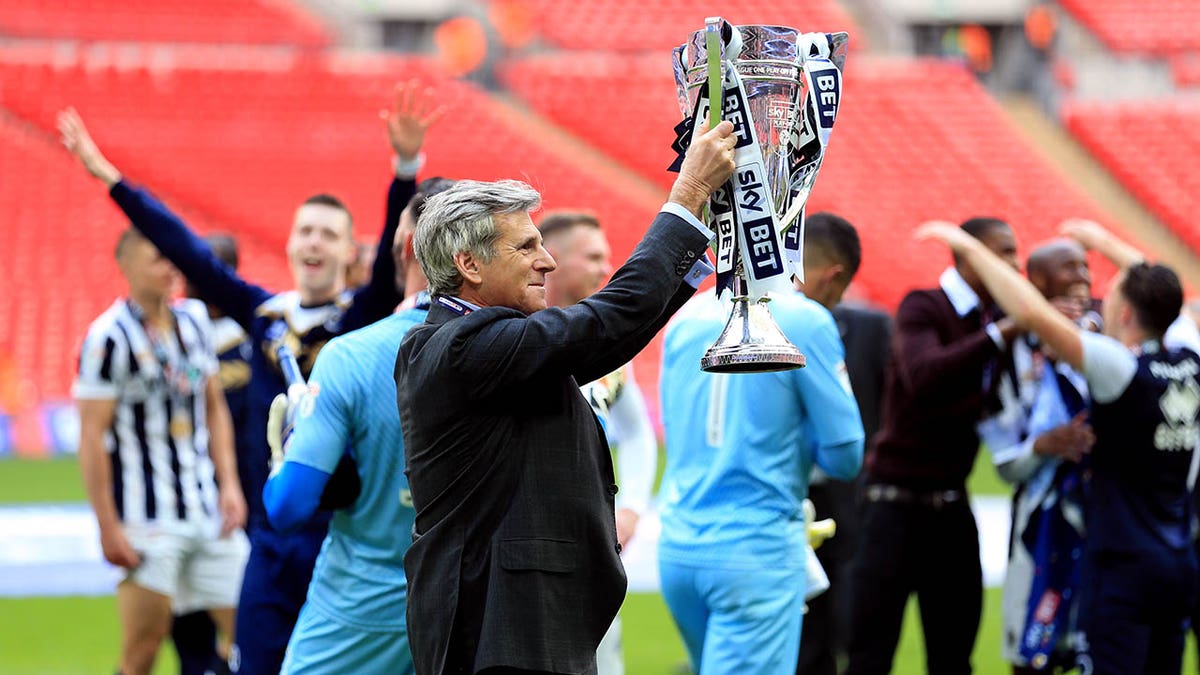 Millwall Chairman John Berylson holds a trophy