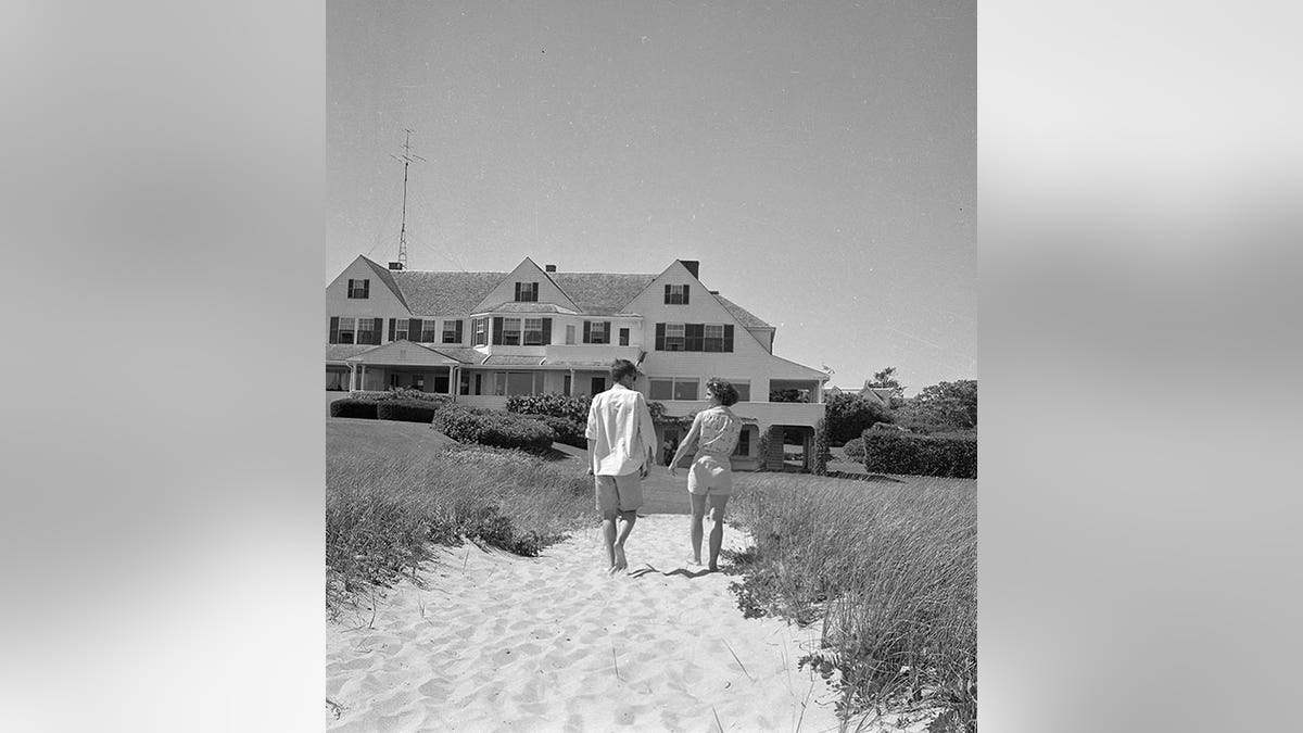 John F. Kennedy and Jackie walking towards the house in Hyannis Port