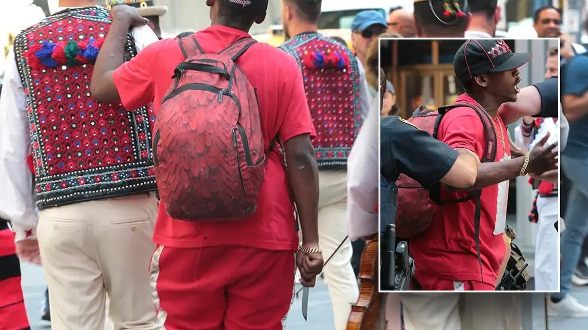 man in red clutching knife in Times Square
