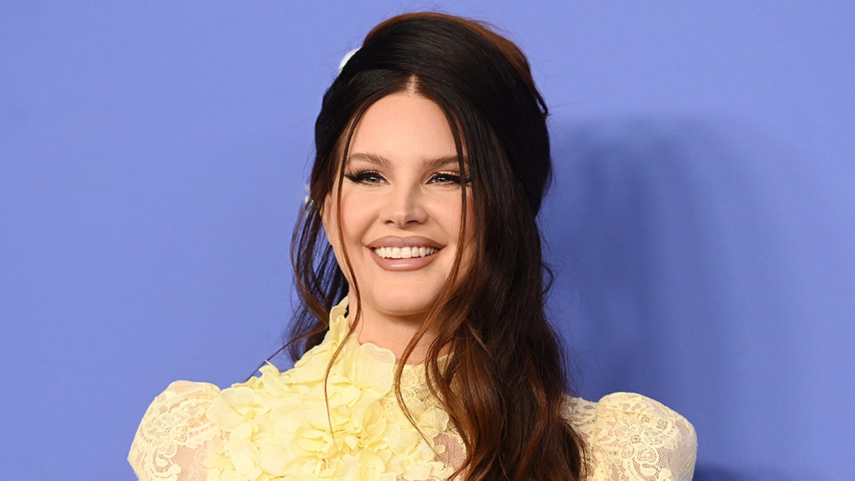 Lana Del Rey wears yellow lace dress on red carpet