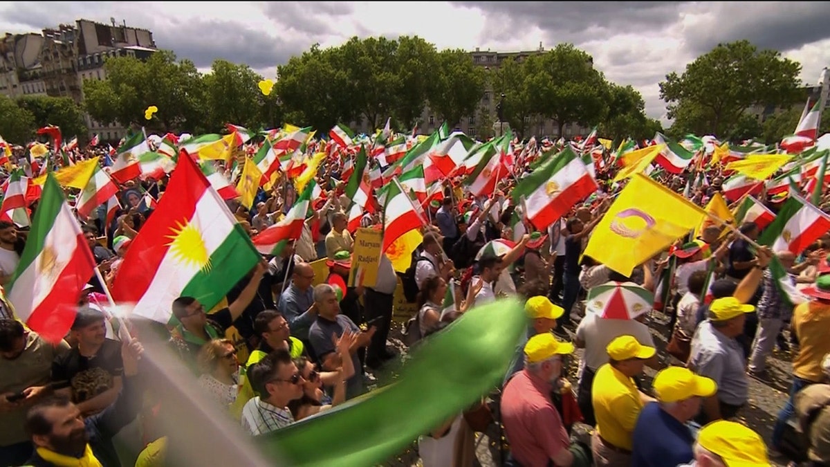 Thousands of people wave Iranian flags in the streets of Paris