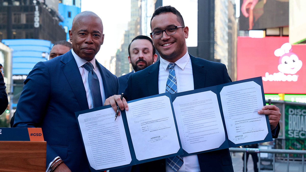 NYC Mayor Eric Adams and City Councilman Shaun Abreu hold up bill making Times Square a gun free zone