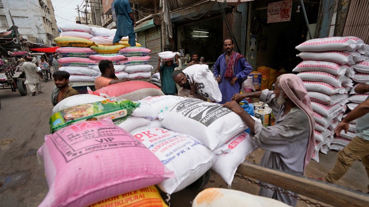 Laborers load sacks of lentils in Pakistan