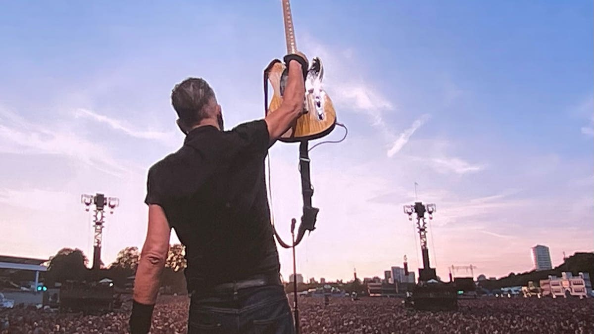 Bruce Springsteen holds up guitar during performance