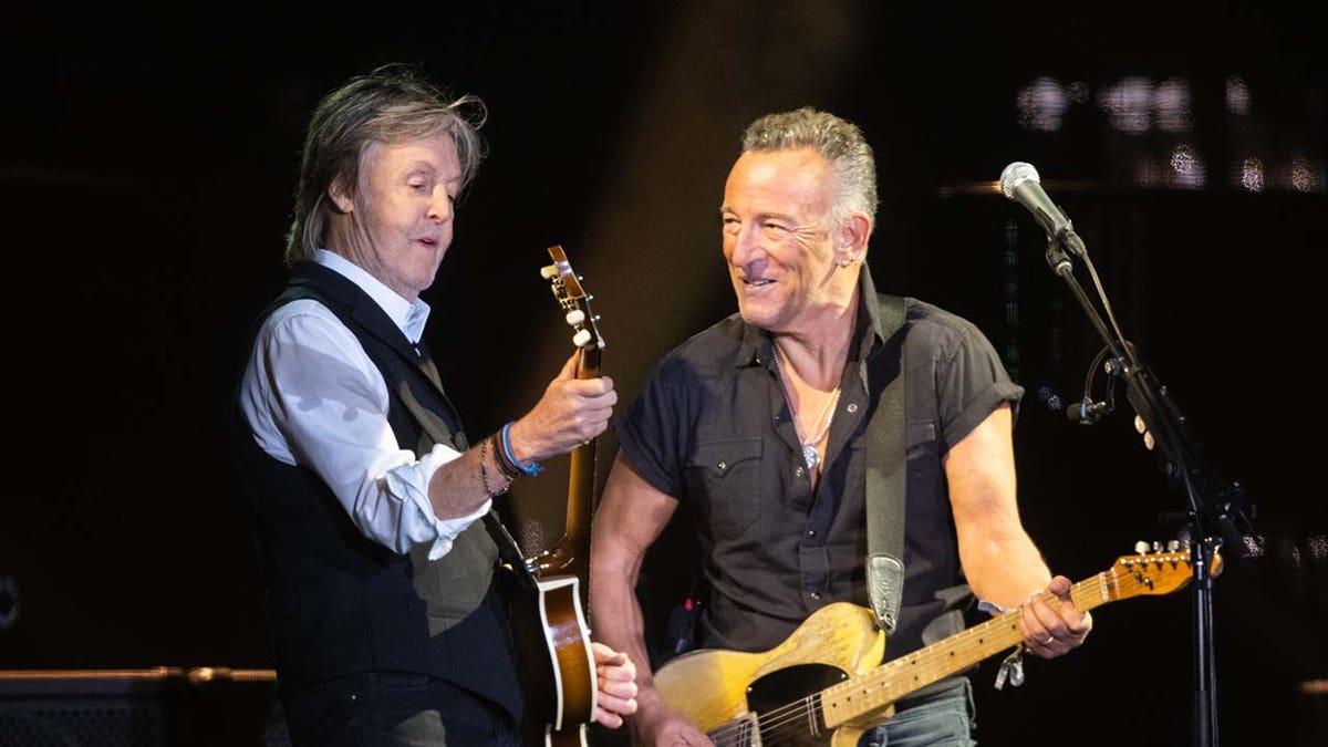 Paul McCartney performing with Bruce Springsteen