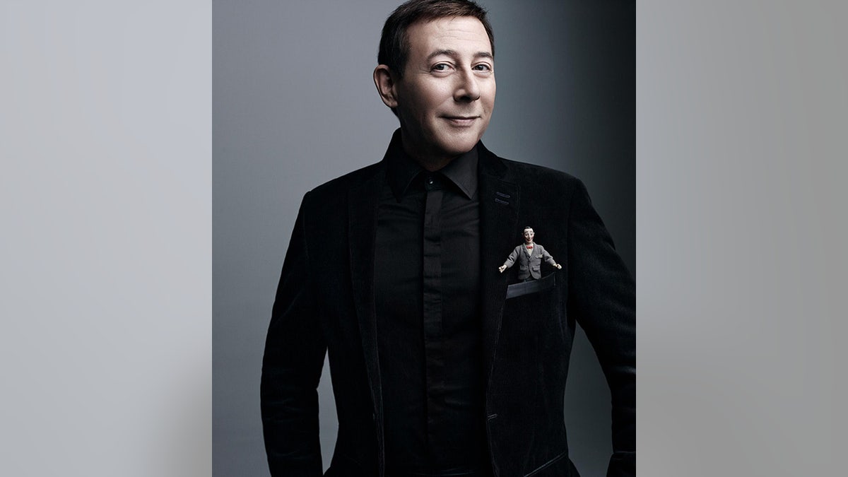 Paul Reubens in a black suit in photo released for his death