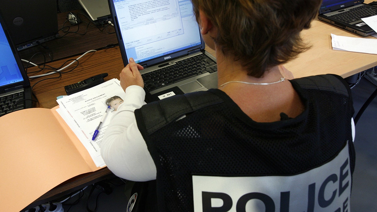 A policewoman working on a computer