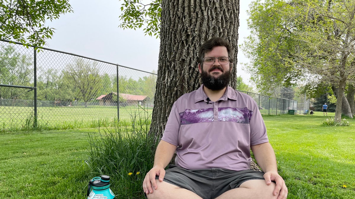 Psychedelic-assisted therapist sits by tree