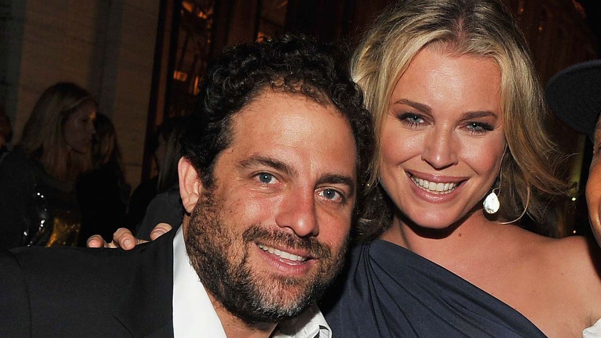 Rebecca Romijn smiling with Brett Ratner