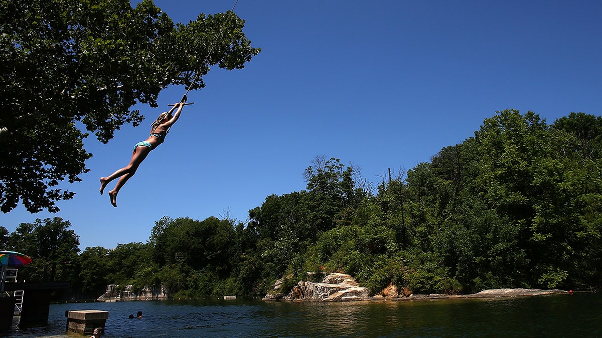 A woman swinging on a rope swing