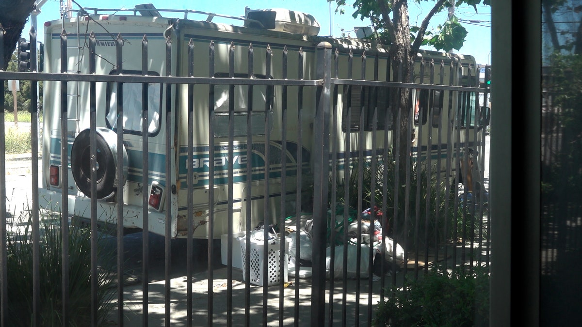 RV camped on side of street outside of Oakland apartment