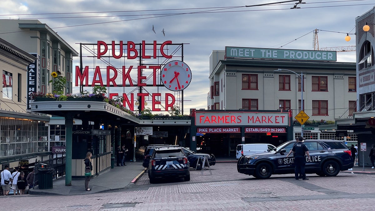 Agentes de policía de Seattle se encuentran cerca del mercado Pike Place el martes 11 de julio de 2023.