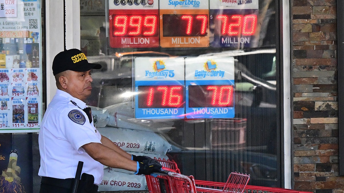 security guard walks past lottery signs