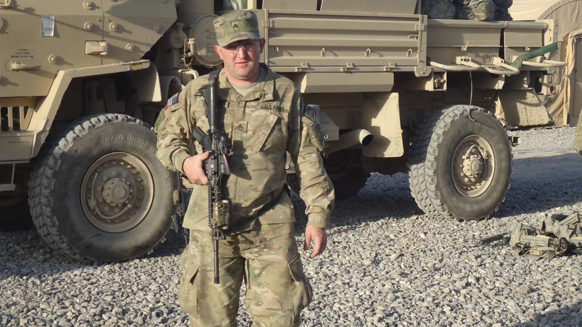 Monte Bernardo in the army in front of a truck