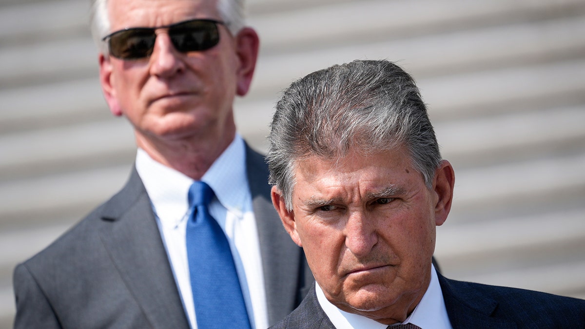 Joe Manchin and Tommy Tuberville on the steps of the Capitol building