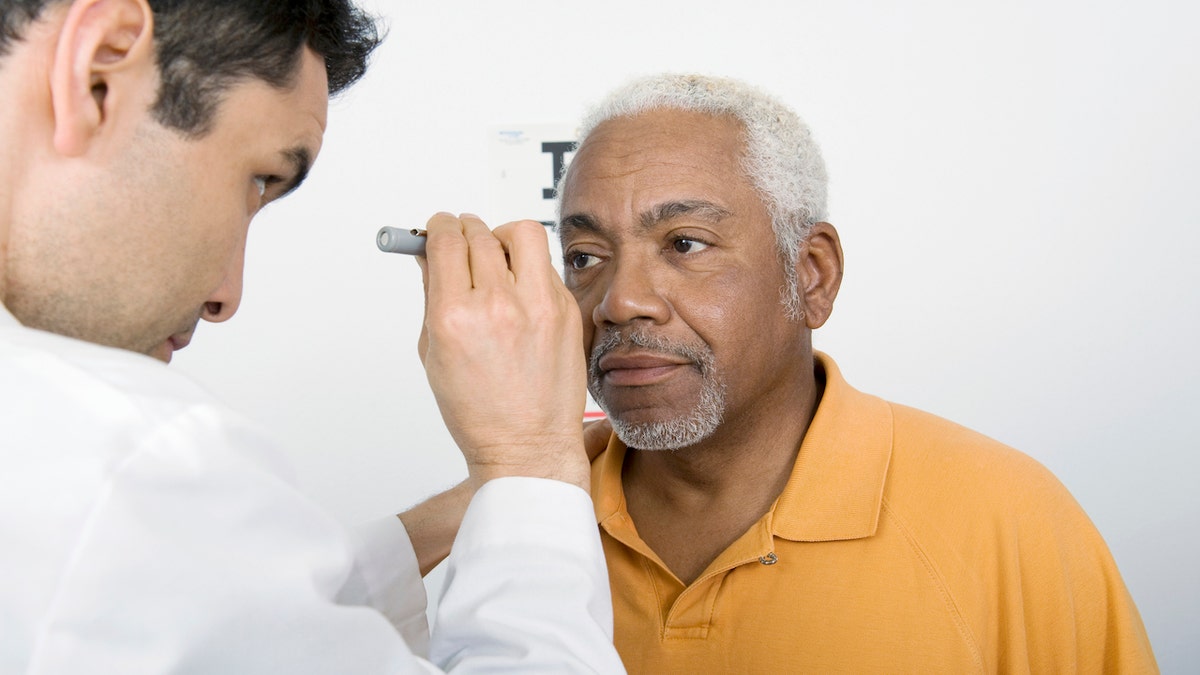 Senior man eye exam