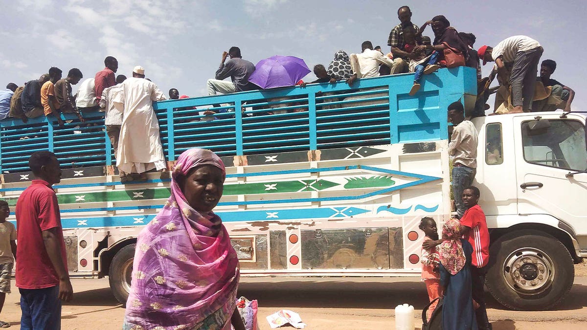 Sudan residents board truck