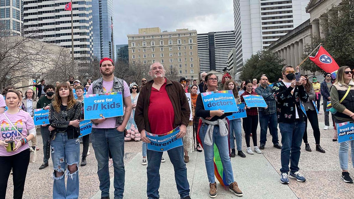 Transgender advocates holding signs