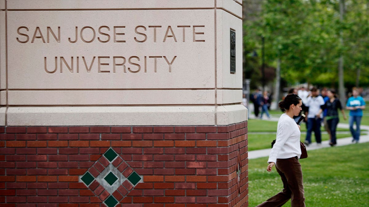 student walks on San Jose State University campus