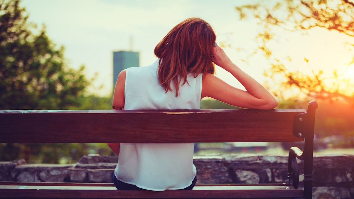 Sad woman on park bench