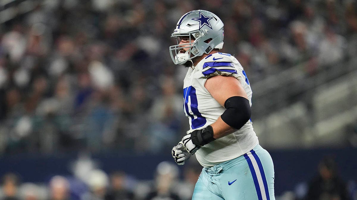 Zack Martin takes the field before a game against the Eagles