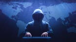 Ominous figure typing on a keyboard.