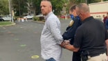 Gabriel Rench arrested outside by two officers
