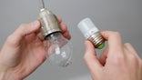 BERLIN, GERMANY - OCTOBER 17: Energy savings through energy-efficient products. An incandescent light bulb is replaced by a LED lamp. (Photo illustration by Thomas Trutschel/Photothek via Getty Images)