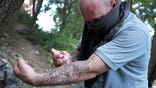 Chris, a homeless heroin addict, pauses to shoot-up by a railway underpass in the Kensington section of Philadelphia which has become a hub for heroin use on July 31, 2017 in Philadelphia, Pennsylvania.