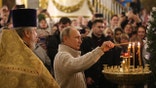SAINT PETERSBURG, RUSSIA - JANUARY 7: (RUSSIA OUT) Russian President Vladimir Putin (R) lights a candle during the Mass marking the Russian Orthodox Christmas at the Transfiguraton Cathedral January 7, 2020 in Saint Petersburg, Russia. Putin travels to Istanbul on January 9 for the opening of the TurkStream gas pipeline. (Photo by Mikhail Svetlov/Getty Images)