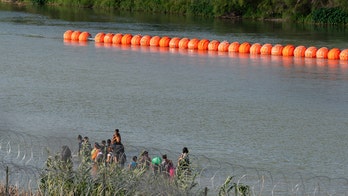 Justice Department sues Texas over floating border barrier in the Rio Grande