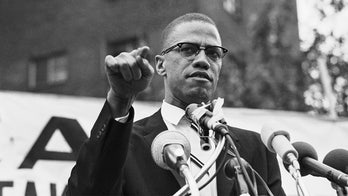 Witness to Malcolm X's assassination says he heard police ask 'Is he with us?' as they restrained killer