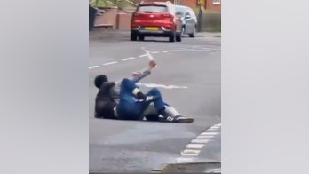Man fends off attacker who tries to stab him as shocked onlookers shout for help: video