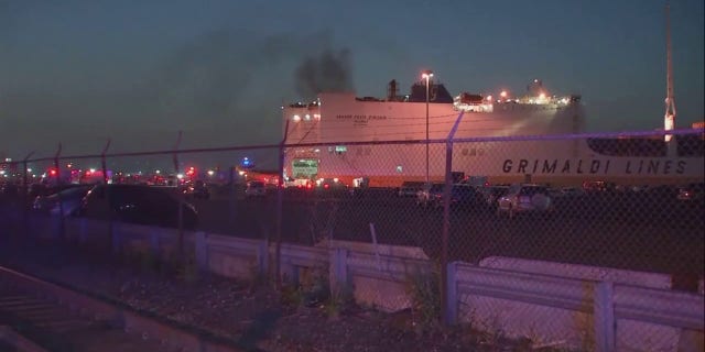 smoke rising from cargo ship