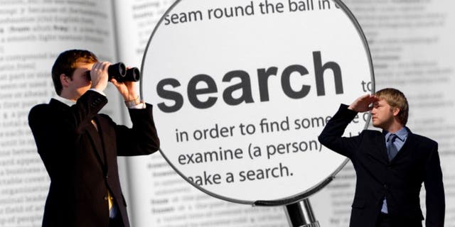 Two people look around with binoculars, magnifying glass over the word "search"