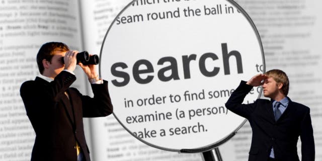 Two men look around with binoculars, magnifying glass over the word "search"