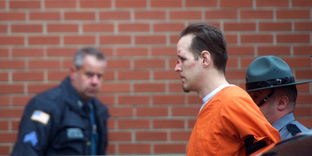 Eric Matthew Frein is taken by police officers into Pike County Courthouse for an arraignment in Milford, Pennsylvania