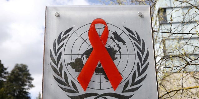 A logo is pictured outside a building of the United Nations AIDS agency