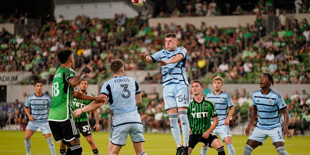 Soccer player head butting the ball