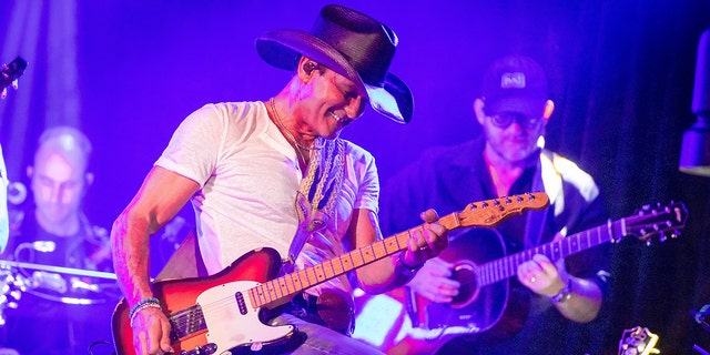 Tim McGraw performing on stage at Whiskey Go Go
