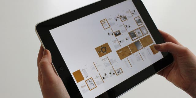 Photo of a woman holding her iPad.