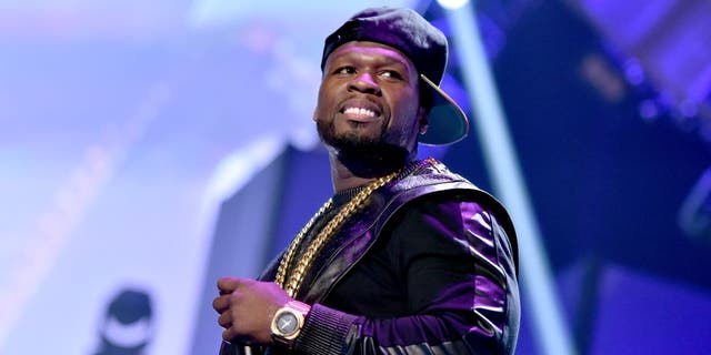50 Cent performing with baseball cap