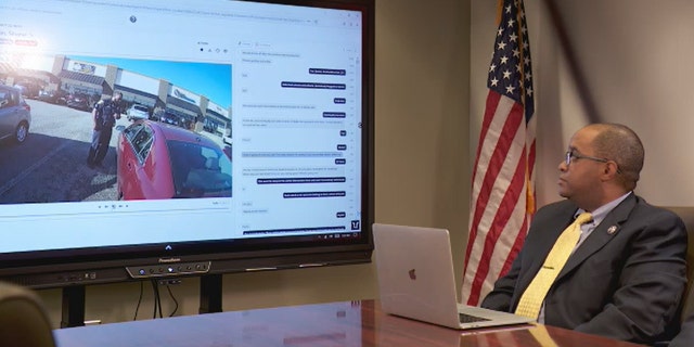 Officer sitting at a desk monitoring footage
