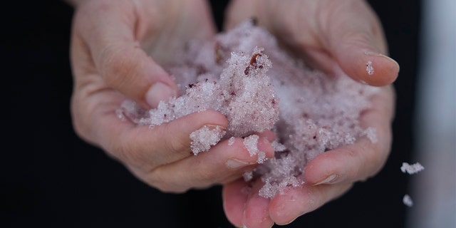 Jana Brough walk on pink snow mountainside