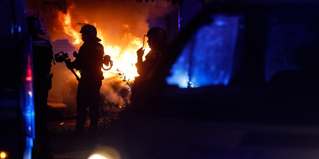 Car burning in the street as French police respond to riots