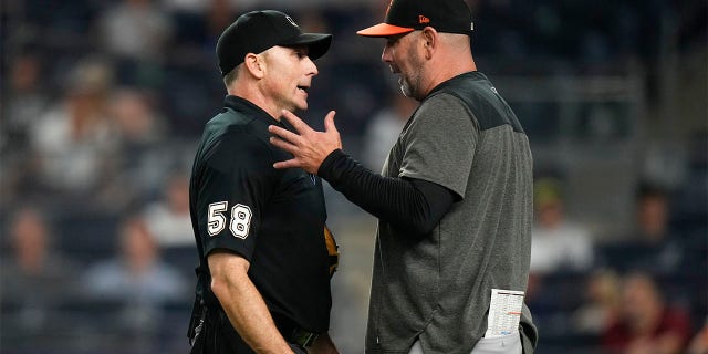 Brandon Hyde talks to the umpire after being ejected