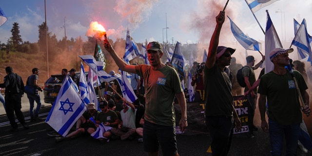 Demonstrators block a highway leading to Jerusalem